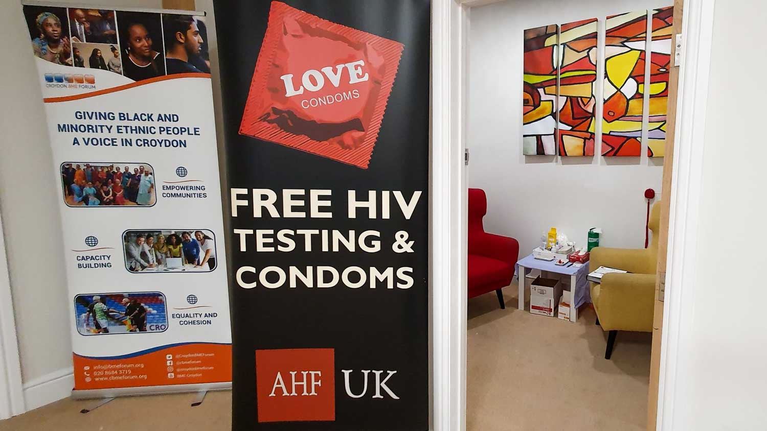 Door outside the HIV testing room with HIV prevention promotional posters and artwork